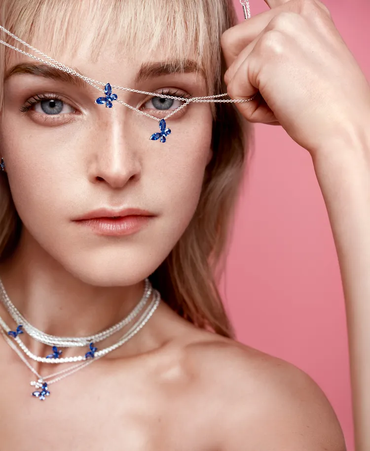 以925銀項鍊搭配翩然起舞的蝴蝶吊墜，鑲嵌藍色欖尖形切割與梨形人造水晶增添華麗視覺。品牌提供