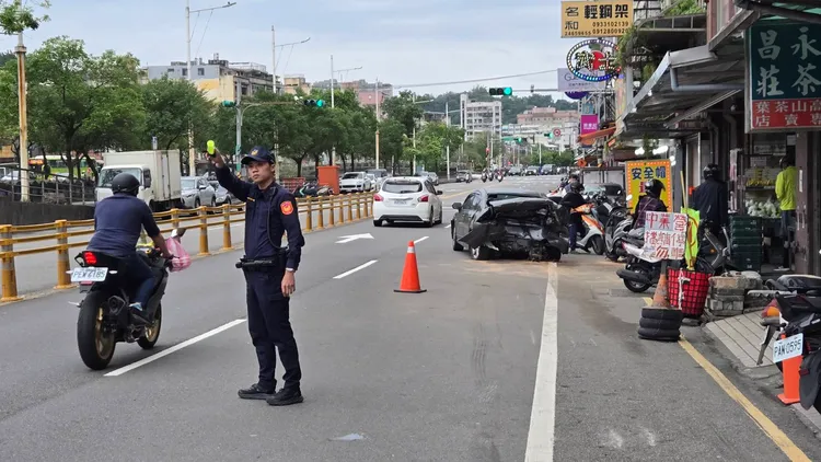 路邊一輛黑色轎車遭楊男追撞，車尾出現嚴重損毀。葉先鵬攝