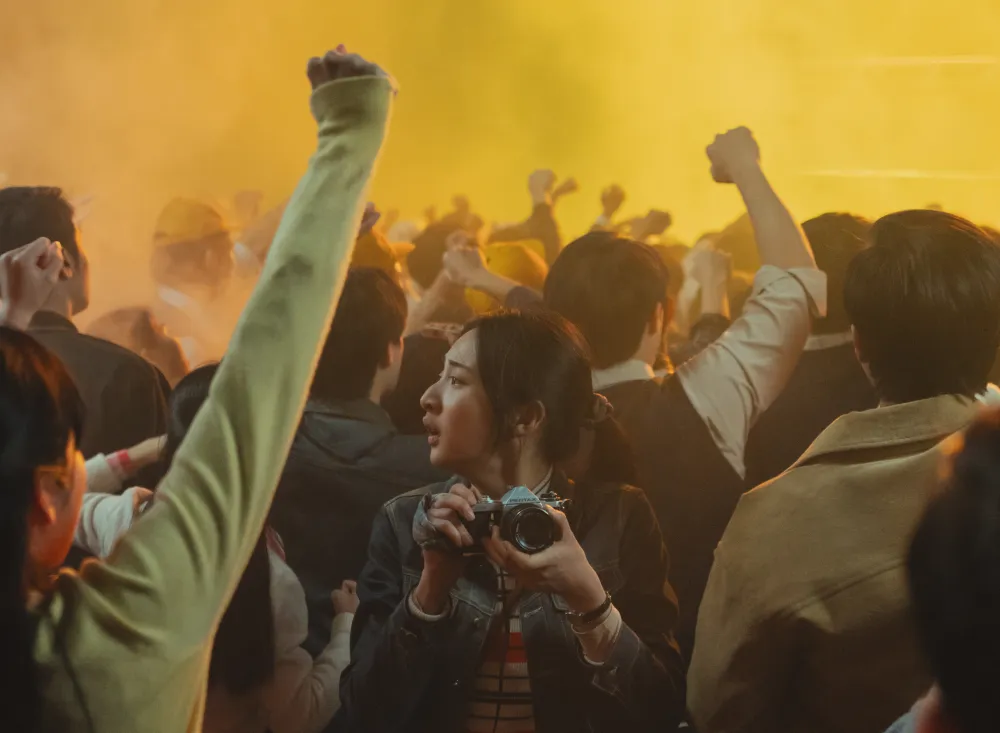 《那张照片里的我们》出动300名临演打造逼真抗议场面，李沐饰演的贤英在人群中记录下一切。瀚草文创GrX STUDIO提供