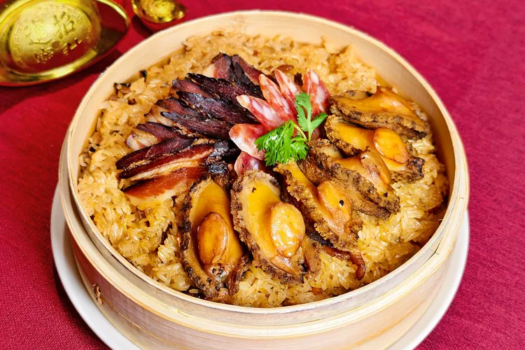凱華樓年菜「老廣臘味九孔鮑魚飯」堆疊油飯、臘味與九孔鮑魚的三重香氣。JR東日本大飯店台北提供