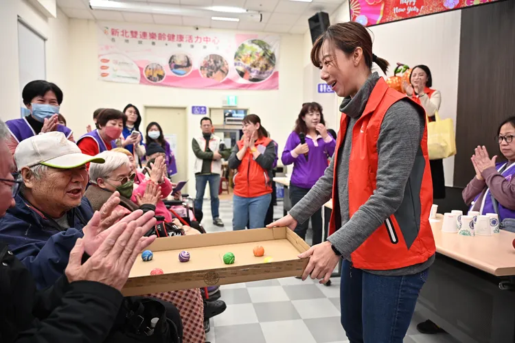 郭曉玲與長輩一同參與結合體力與反應力訓練的團康活動，現場氣氛溫馨熱絡。永齡基金會提供