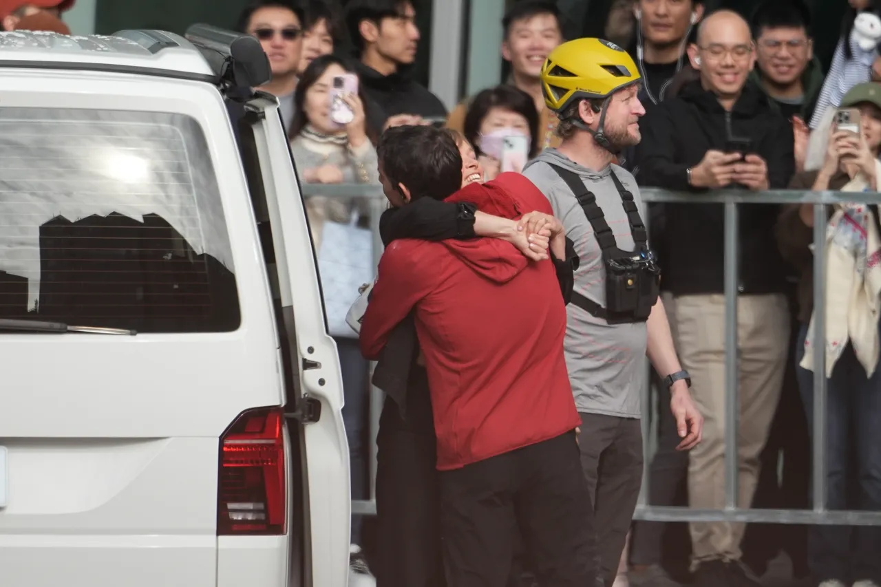 霍諾德在徒手攀登台北101前與妻子相擁。彭欣偉攝