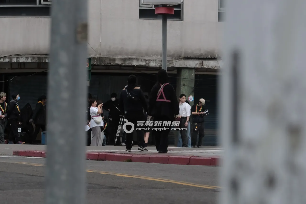 坂口健太郎（右二）持續在大馬路上拍戲。特勤中心攝
