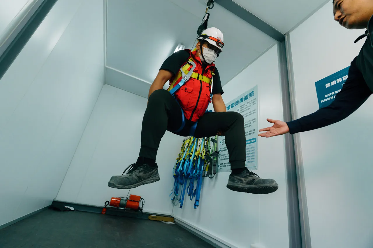 安全危害模擬訓練中心導入體感訓練，加深安全意識教育，圖為安全帶吊掛時，引導學員實施正確防護動作。台積電提供