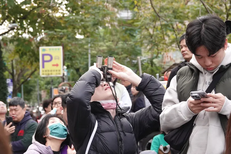 霍諾德挑戰徒手攀登台北101，民眾手持望遠鏡前來觀看。莊宗達攝