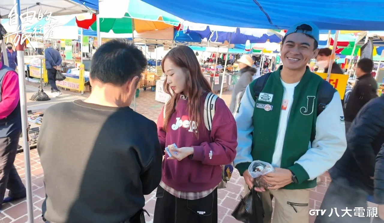 製作團隊前往市集被攤商招待餵食，咪蕾（中）一度被老闆追著要電話，融融笑了。八大提供