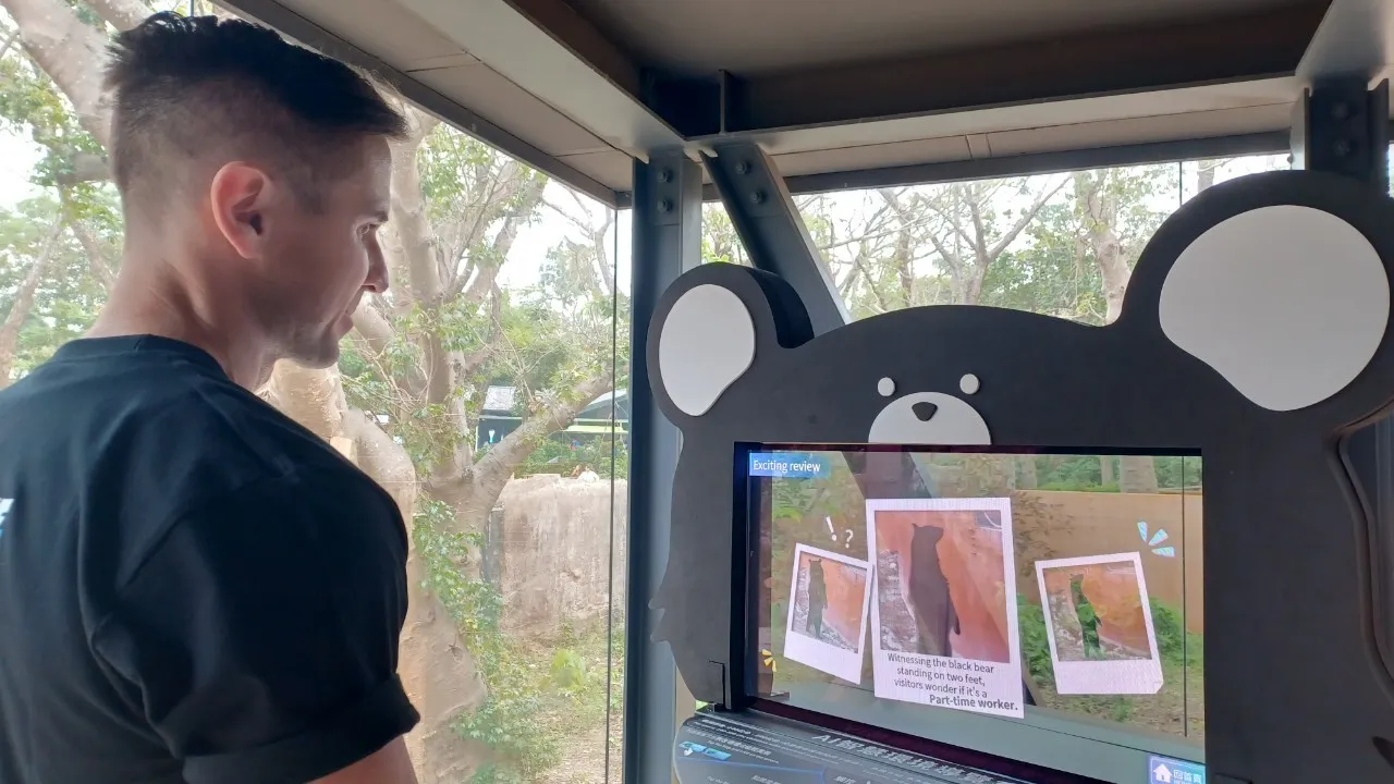 外國遊客於黑熊廊道體驗「AI智慧環境導覽系統」。翻攝畫面