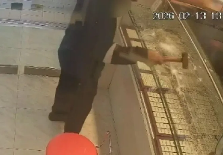 林男持榔頭敲打銀樓展示櫃。翻攝畫面