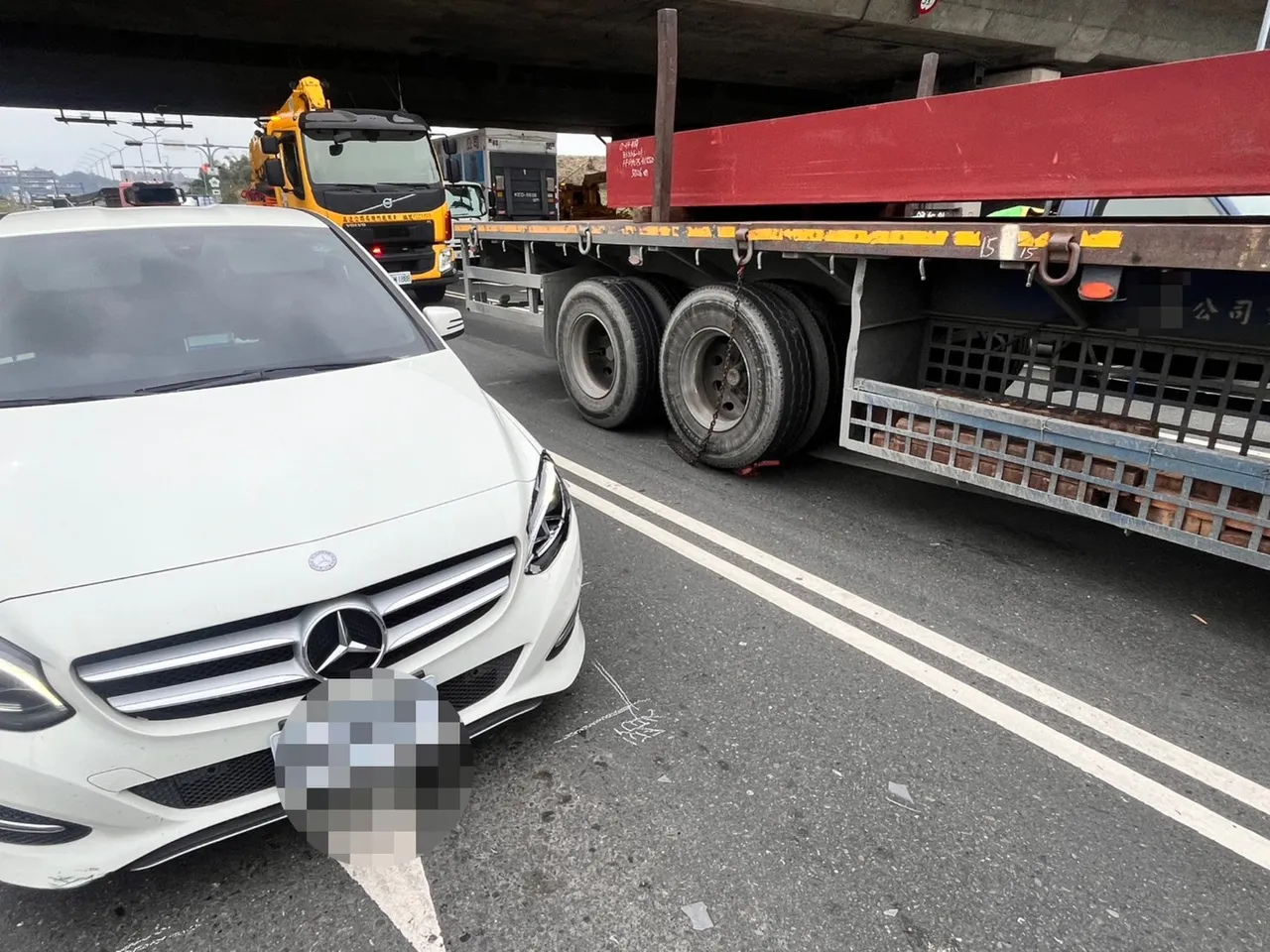 自小客車遭事故噴濺物品波及，造成車燈受損。翻攝畫面