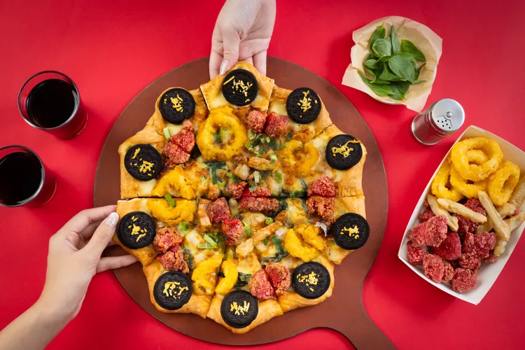 「OREO餅乾台味鹹酥雞比薩」可吃到網友票選鹹酥雞攤必吃排行榜前3名，包含鹹酥雞、魷魚圈以及甜不辣等配料。必勝客提供