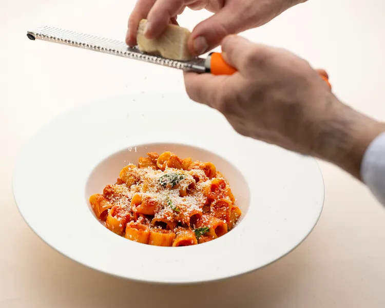 「西西里塔利亞圓茄 鹽味起司 寬管麵」 烘烤茄香與番茄紅醬交融，現刨如初雪般的鹽漬風乾羊乳酪，堆疊出暖心又令人上癮的義式風味。每道490元。台北遠東香格里拉提供