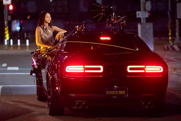 曾薀帆坐在車邊拍攝，險象環生。品婕娛樂提供