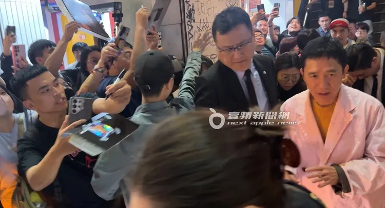 結束電影映後活動，梁朝偉被大批粉絲包圍要求簽名合照。特勤中心攝