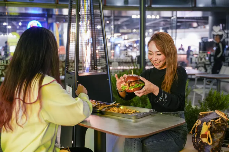 端起熱騰騰、肉汁四溢的漢堡，大快朵頤。田欣雲攝