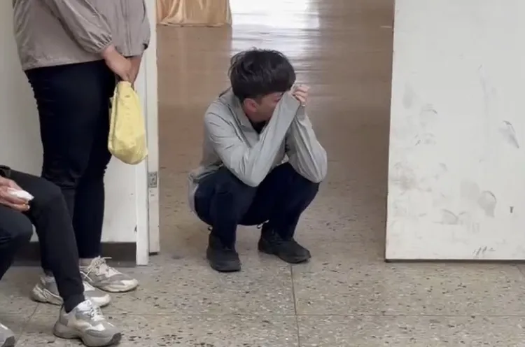 同是警察的鄭女未婚夫蹲地掩面啜泣，場面極度哀戚。讀者提供