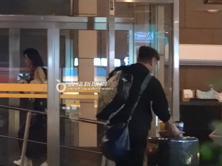 蕭薔（左）抱著愛犬走在前，護花男跟在後面拖著行李一同返家。特勤中心攝