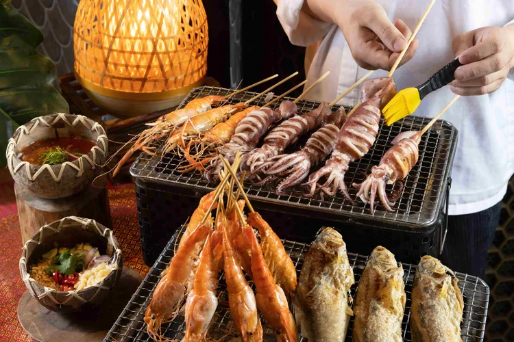 泰市場2周年歡慶活動中，吸睛菜色包含炭香四溢的「現烤海鮮檯」，匯集泰國蝦、魷魚與午仔魚等精選海味，經炭烤釋放細緻焦香，搭配石臼辣醬與花生香蒜汁更加襯托海鮮的鮮甜滋味。台北晶華提供