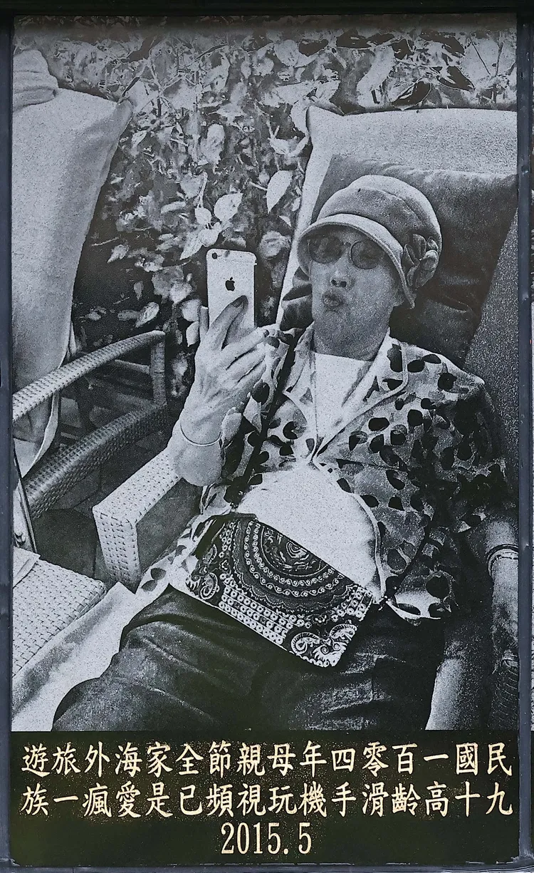 2015年高齡90歲的初永真，全家海外旅遊，手拿iPhone 8俏皮噘嘴。特勤中心翻攝