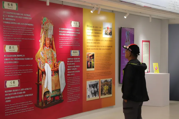 旅客駐足欣賞媽祖展示牆，透過圖文深入認識媽祖信仰與進香文化內涵。財團法人昇恒昌基金會提供
