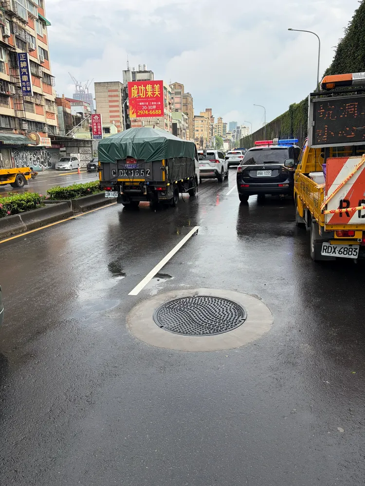 維修單位將人孔蓋復位。北市府提供