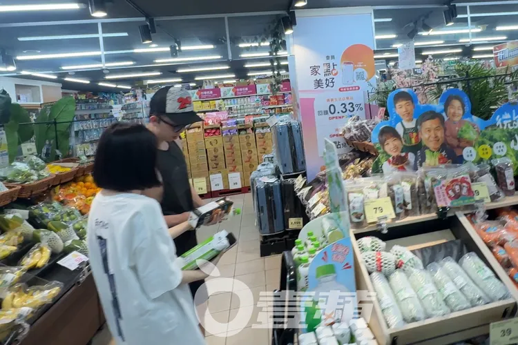 短髮妹（左）去冰櫃拿1000ml紐西蘭進口草飼牛乳，與孫安佐會合討論。特勤中心攝