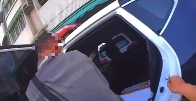 警方用紙箱厚紙板及報紙鋪墊座位上，讓陳嫌坐進警車。翻攝畫面