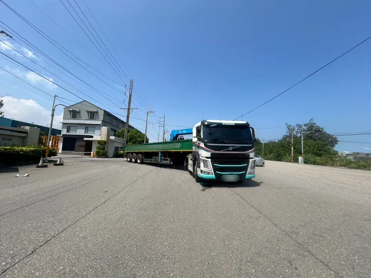 曳引車滿載鋼筋從廠內出來，車身一半在車道，當時交通號誌為綠燈。民眾提供