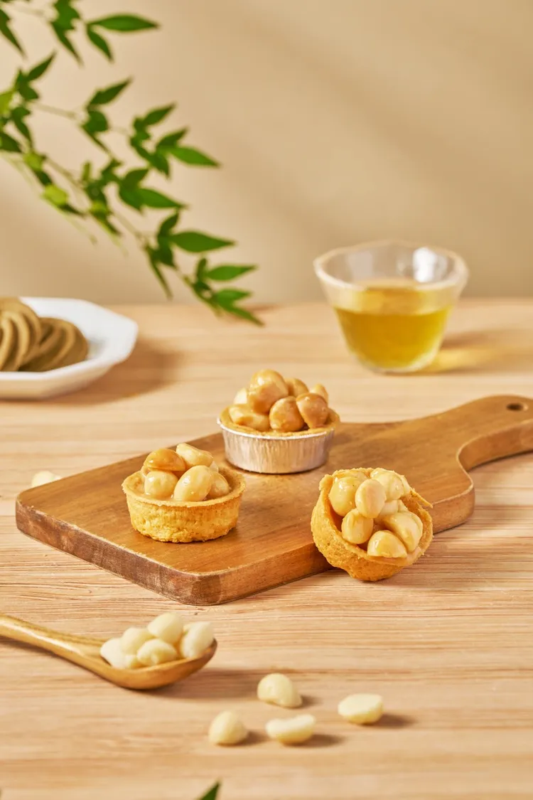 琥珀色夏威夷豆搭配鮮奶油、蜂蜜與奶油熬煮出的奶香焦糖，製作出香甜不黏口，外酥內脆的「夏威夷豆塔」。查理布朗烘焙提供