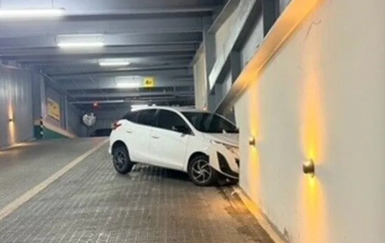 白車離開停車場時失控自撞牆壁，上演烏龍「穿牆秀」。翻攝畫面