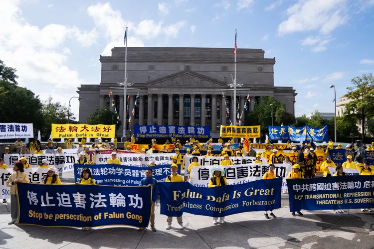 法輪功團體也到場拉布條示威。美聯社