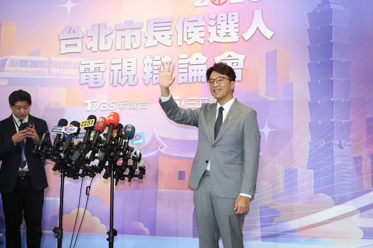 沈伯洋今穿淺灰色西裝出席電視辯論會。
