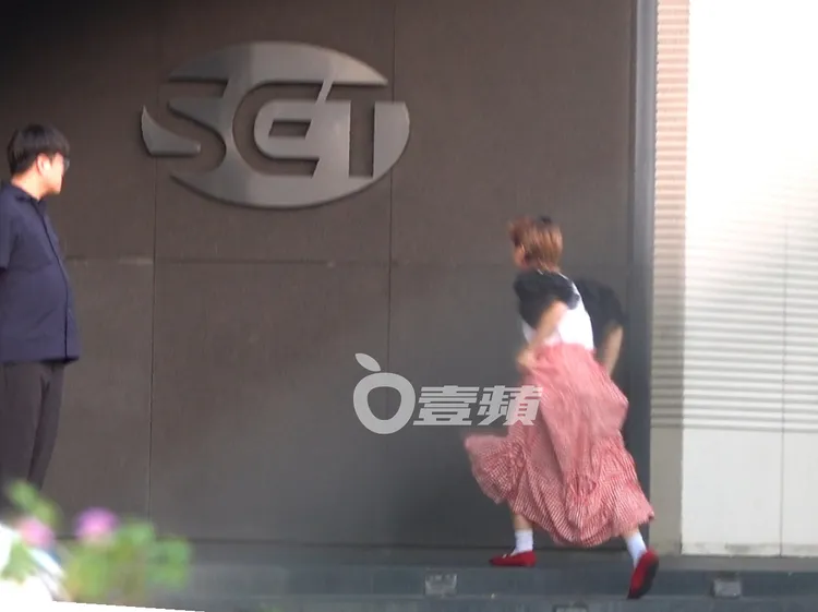 Lulu上車後發現忘記拿東西，又急忙拉著裙子跑回電視台。特勤中心攝