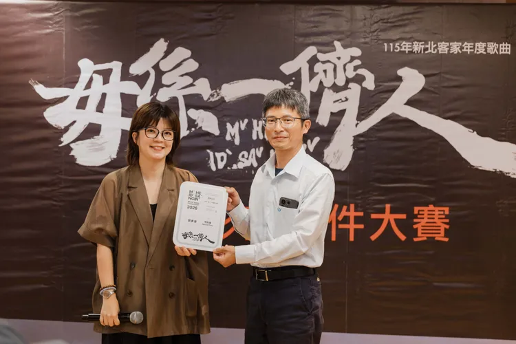新北市客家事務局局長劉冠吟(左)與〈毋係一儕人〉MV短影音徵件比賽特別獎領獎代表(右)合影，紀念新北市捷運局工程管理科科長周茂益（芋仔Or）作品。客家局提供